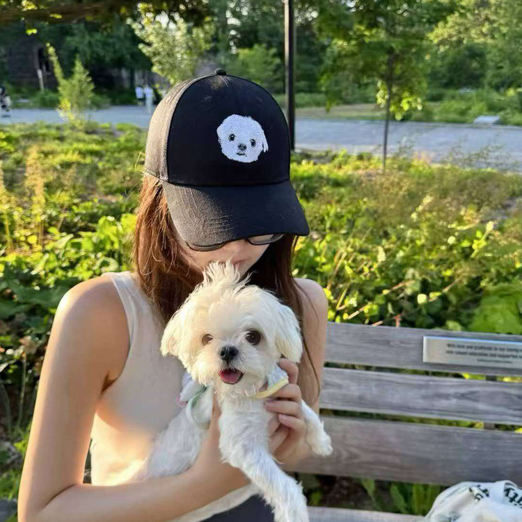 White Maltese dog with owner wearing custom embroidered pet portrait hat - customer review